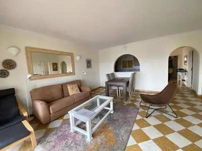 a living room with a couch and a table at Luz dream apartment 22G above beach in Luz