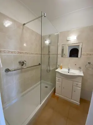 a bathroom with a shower and a sink at Luz dream apartment 22G above beach in Luz