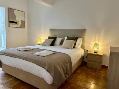 a bedroom with a large bed with two lamps at Anita & Leonel's House B in Gaula