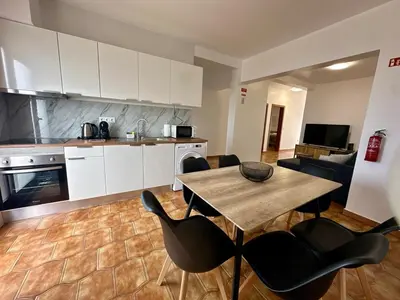 a kitchen and living room with a table and chairs at Anita & Leonel's House B in Gaula