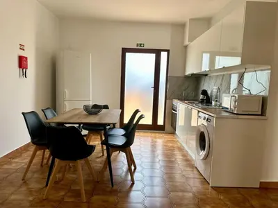 a kitchen with a table and chairs in a kitchen at Anita & Leonel's House B in Gaula