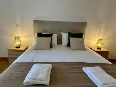 a bedroom with a large bed with two towels on it at Anita & Leonel's House B in Gaula