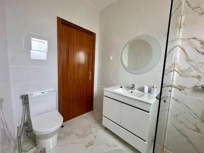 a bathroom with a toilet and a sink and a mirror at Anita & Leonel's House B in Gaula