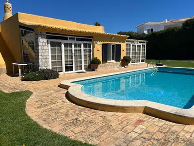 a swimming pool in front of a house at Vivenda Romana - By Staywise in Lagos