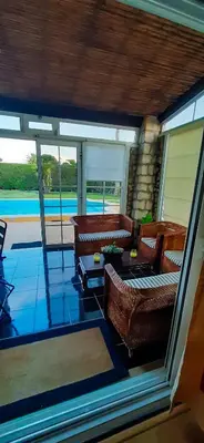 a living room with couches and a view of a pool at Vivenda Romana - By Staywise in Lagos
