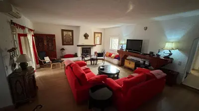 a living room with red couches and a fireplace at Vivenda Romana - By Staywise in Lagos