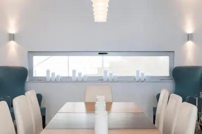 a dining room with a table and chairs at Villa Mar Azul in Salema