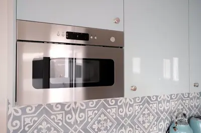 a stainless steel oven in a kitchen with white cabinets at Ocean Bay Panoramic View in Funchal