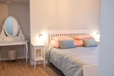 a bedroom with a white bed with pillows and a mirror at Ocean Bay Panoramic View in Funchal