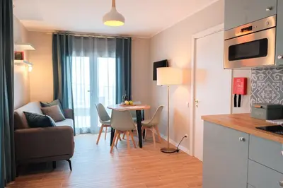 a kitchen and living room with a table and chairs at Ocean Bay Panoramic View in Funchal