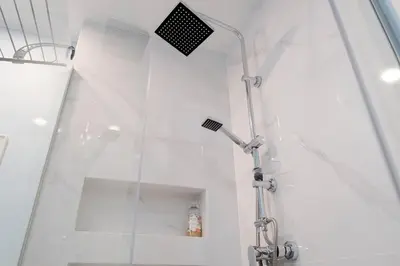 a shower with a glass wall in a bathroom at Ocean Bay Panoramic View in Funchal