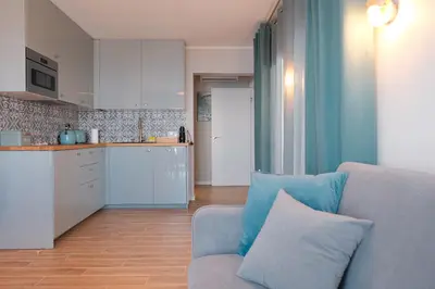 a living room with a couch and a kitchen at Ocean Bay Panoramic View in Funchal
