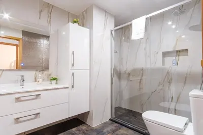 a bathroom with a shower and a toilet and a sink at GuestReady - Serene Funchal Getaway in Funchal