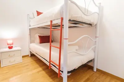 a bedroom with two bunk beds and a table at GuestReady - Serene Funchal Getaway in Funchal