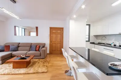 a kitchen and living room with a couch and a table at GuestReady - Serene Funchal Getaway in Funchal