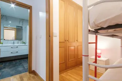a room with a bunk bed and a bathroom at GuestReady - Serene Funchal Getaway in Funchal