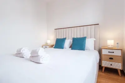 a bedroom with a large white bed with towels on it at GuestReady - Serene Funchal Getaway in Funchal
