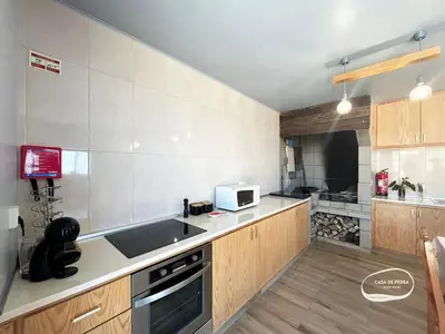 a kitchen with a sink and a microwave at Casa de Pedra AL in Ponta do Pargo