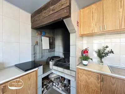 a kitchen with an open oven in the middle at Casa de Pedra AL in Ponta do Pargo