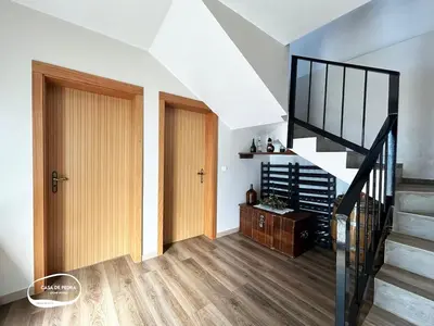 a hallway with two doors and a stair case at Casa de Pedra AL in Ponta do Pargo