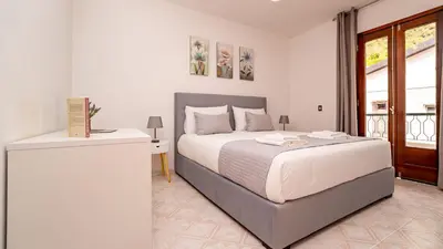 a white bedroom with a bed and a window at Casa Conceição in Ribeira Brava