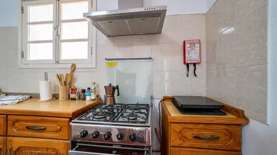 a kitchen with a stove and a counter top at Casa Conceição in Ribeira Brava