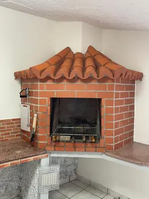 a brick pizza oven with its door open at Casa Conceição in Ribeira Brava