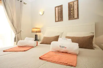 a bedroom with a bed with two towels on it at Apartamento Boavista Golf Resort by Algarving in Lagos