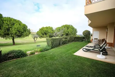 a yard with chairs and a lawn with a view at Apartamento Boavista Golf Resort by Algarving in Lagos