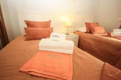a room with two beds with towels on them at Apartamento Boavista Golf Resort by Algarving in Lagos