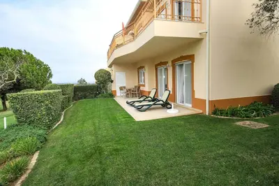 a house with a green lawn in front of it at Apartamento Boavista Golf Resort by Algarving in Lagos
