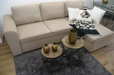 a living room with a couch and two tables at Casa do Prendinha A in Ponta do Pargo