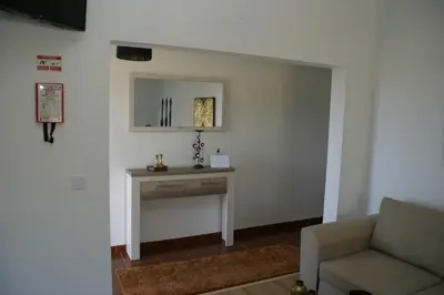 a living room with a table and a chair at Casa do Prendinha A in Ponta do Pargo