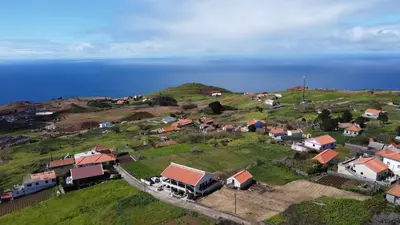 a small village on a hill with the ocean at Casa do Prendinha A in Ponta do Pargo