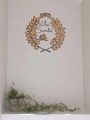 a clock on a wall with a picture of a house at House Vila Santa Ana in Santana