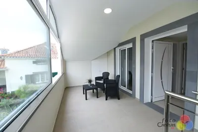 a balcony with a table and chairs and a window at House Vila Santa Ana in Santana