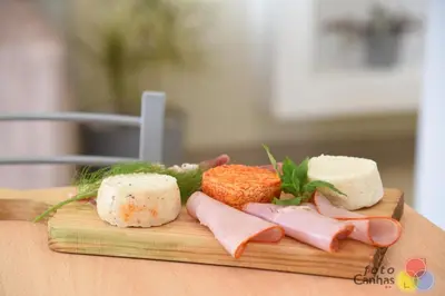 a bunch of different types of cheese on a cutting board at House Vila Santa Ana in Santana