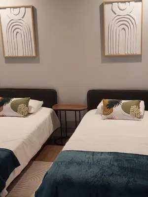 two beds sitting next to each other in a room at Funchal Infinito Azul - Moderno elegante com piscina in Funchal