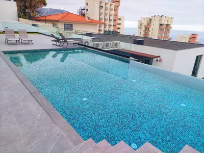 a large swimming pool on top of a building at Funchal Infinito Azul - Moderno elegante com piscina in Funchal