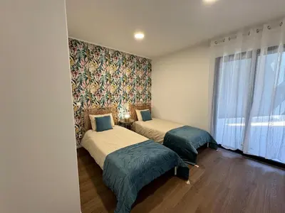 a bedroom with two beds and a wall mural at Stay In Virtudes II in Funchal
