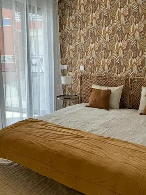 a bedroom with a large bed with a large window at Stay In Virtudes II in Funchal