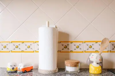 a kitchen counter with a roll of toilet paper and toy cars at 2 minutes walk to the beach Praia da Luz - Casa da Maria in Luz