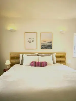 a bedroom with a large white bed with two pillows at 2 minutes walk to the beach Praia da Luz - Casa da Maria in Luz