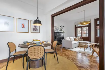 a living room with a table and chairs and a couch at Zino Apartment A - By Wehost in Funchal