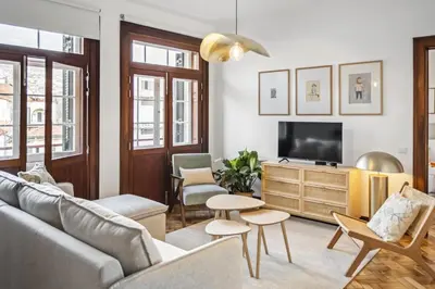 a living room with a couch and a tv at Zino Apartment A - By Wehost in Funchal