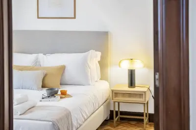 a hotel room with a bed and a table with a lamp at Zino Apartment A - By Wehost in Funchal