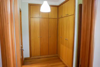 a hallway with wooden cabinets and a light in a room at BiBel Apartment in Funchal