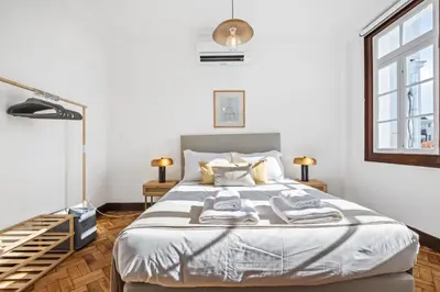 a bedroom with a bed and a window at Zino Apartment B - By Wehost in Funchal
