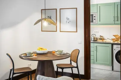 a kitchen with a table and chairs in a kitchen at Zino Apartment B - By Wehost in Funchal