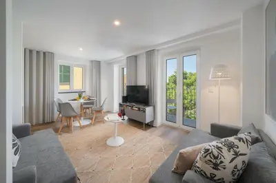 a living room with a couch and a table with a television at OurMadeira - Fort of Old Town Apartments in Funchal